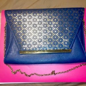 Midnight blue clutch with gold chain and gold overlay